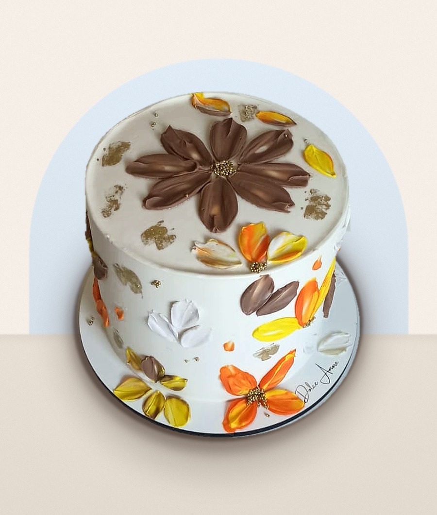Bolo branco decorado com flores em espátula nos tons de marrom, laranja e amarelo